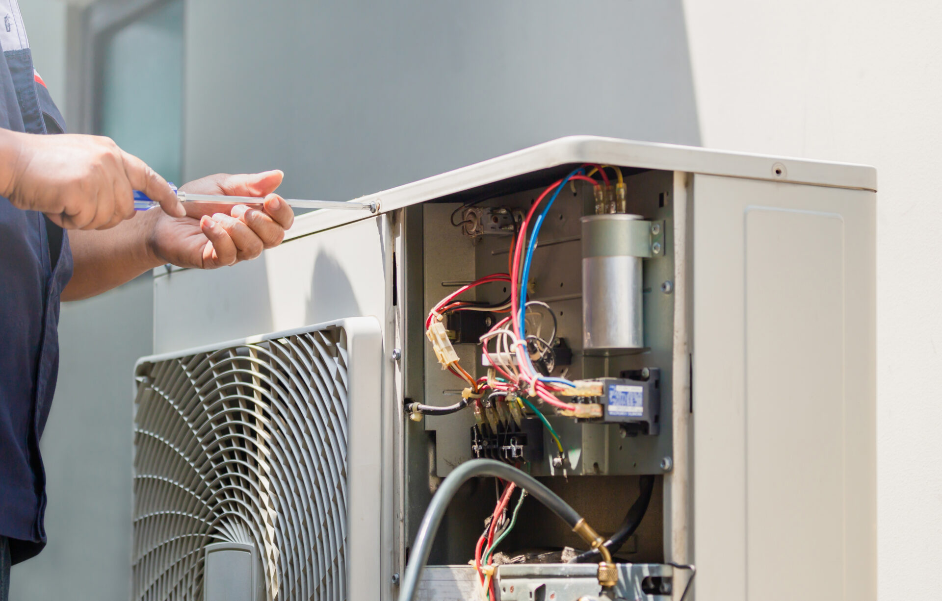 Technician repairing an AC unit