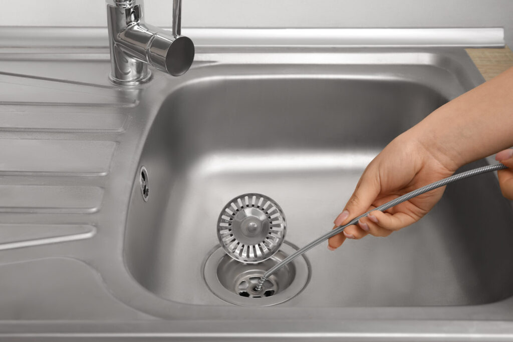 plumber snaking a sink drain