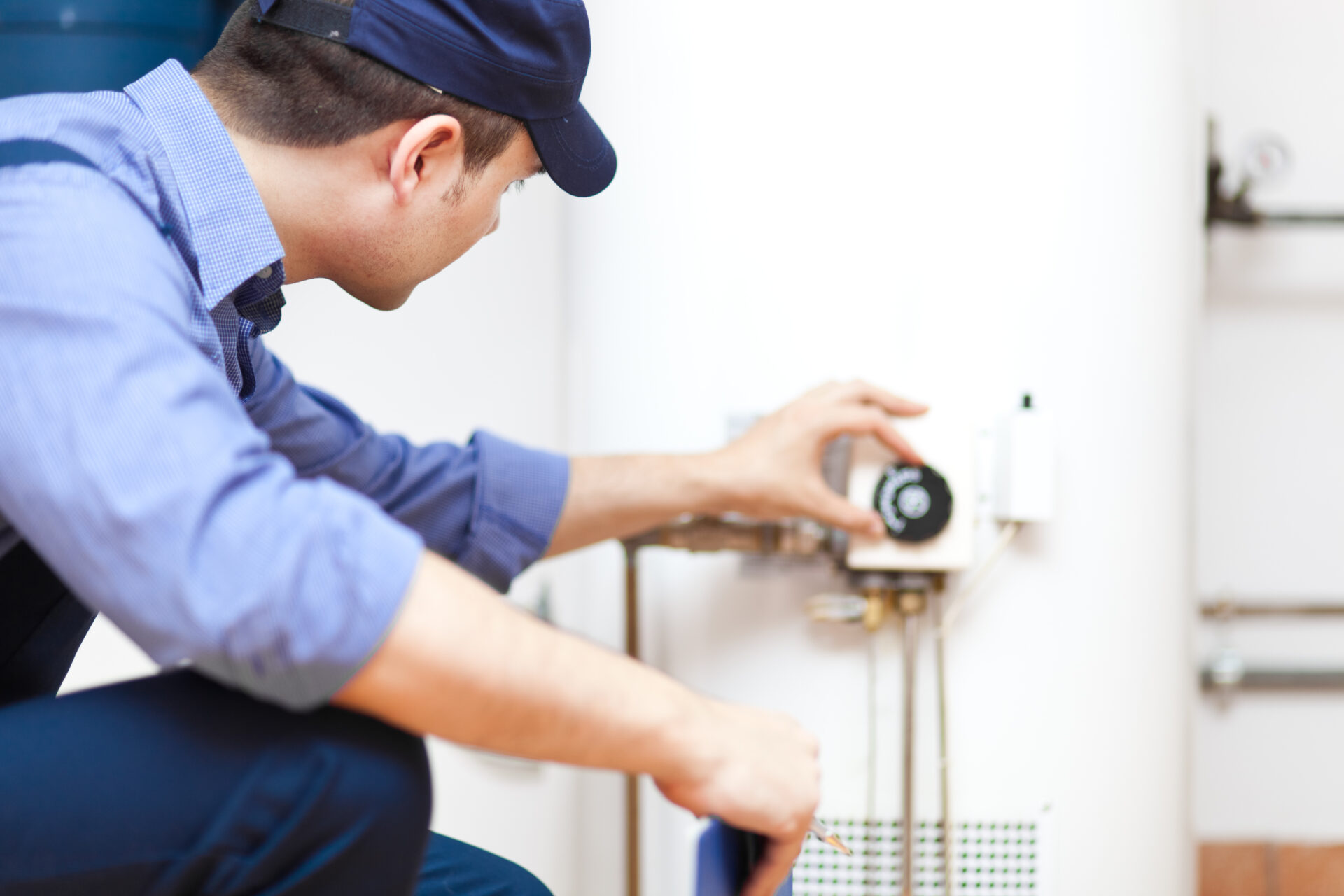 Plumber installing a hot-water heater