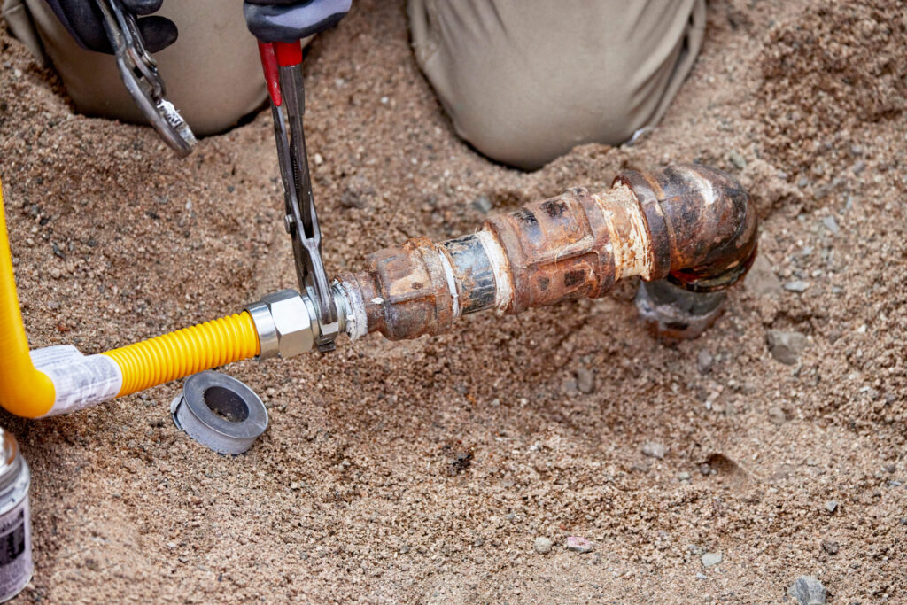 A Plumber hooking up a temporary gas line hookup