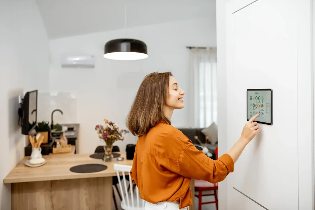 smart thermostat in use by homeowner